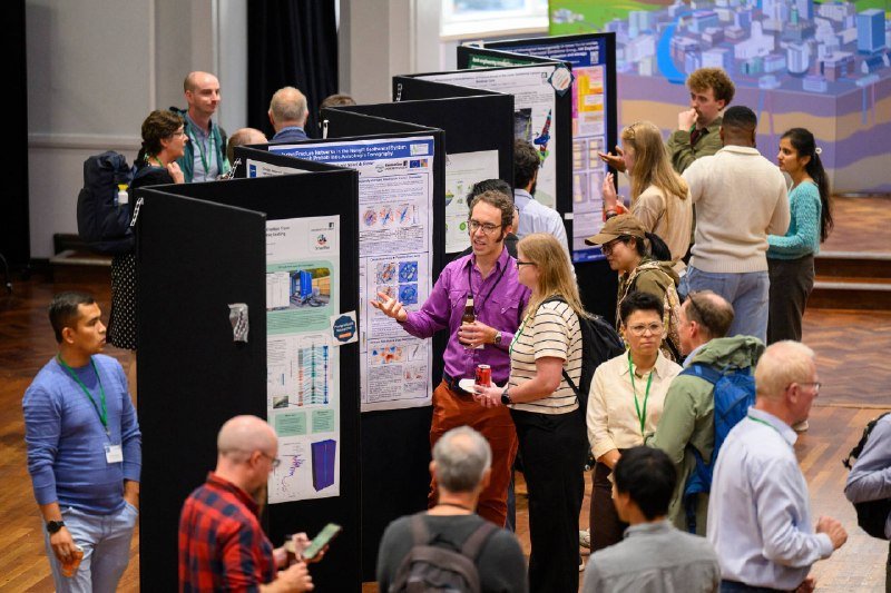 Visitors among poster boards at a research showcase