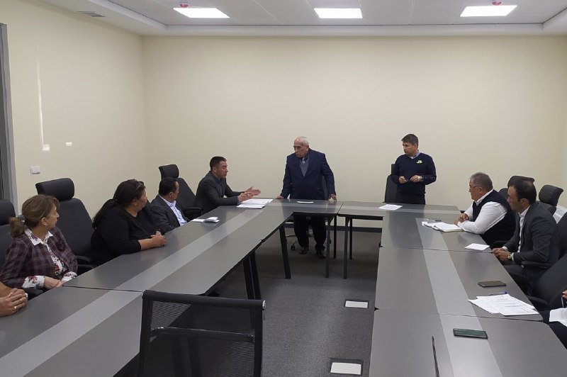 Members of a scientific council seated around tables in a meeting room