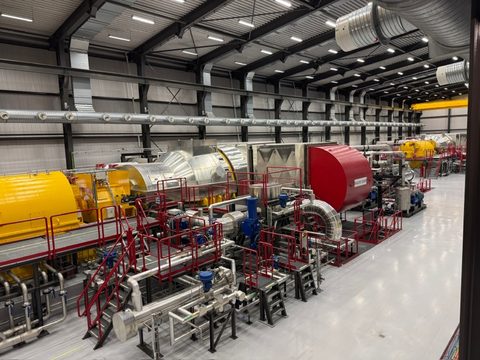 Turbine hall of the Þeistareykir power station with generator units and pipework