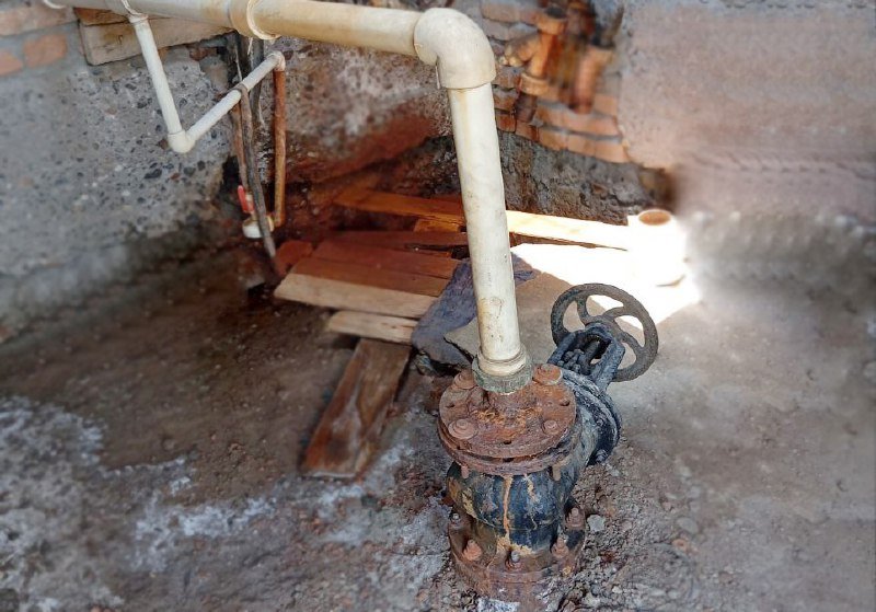 An old wellhead with a pipe and valve