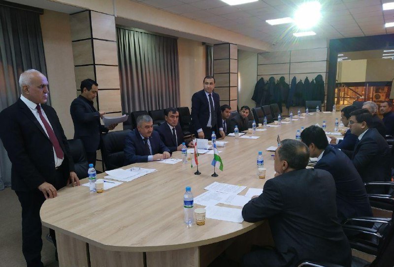Delegations seated at a long meeting table